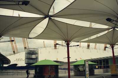 The Millennium Dome roof seen from beneath canopy parasols — London, England (August 2000)