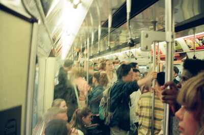 A crowded Underground carriage of standing passengers — London, England (August 2000)