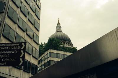 St Paul's dome rising above a St Bartholomew's signpost — London, England (August 2000)