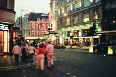 Crowds crossing the West End theatre district at dusk — London, England (August 2000)