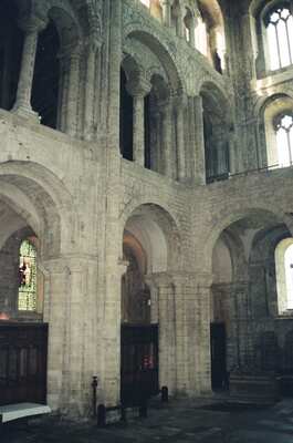 A painted reredos and altar below stained glass — Winchester, England (August 2000)