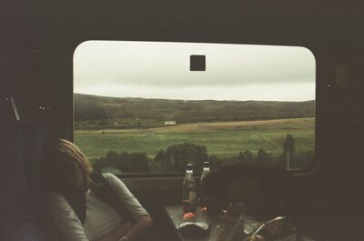 Highland scenery through a train window with passengers — Inverness, Scotland (late July - early August 2000)