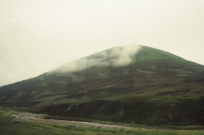 Cloud drifting over a bare green Highland hill — Scottish Highlands, Scotland (late July - early August 2000)