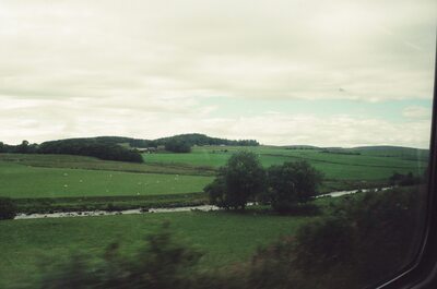 A winding stream through sheep fields near the railway — Aberdeen, Scotland (late July - early August 2000)