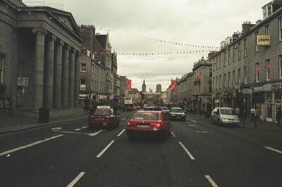 Cars and bunting along Aberdeen's granite Union Street — Aberdeen, Scotland (late July - early August 2000)