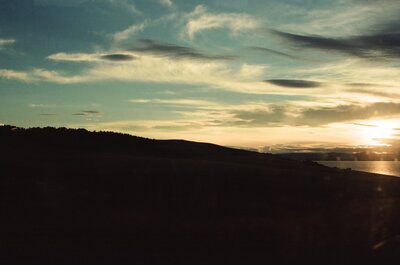 A silhouetted headland against a golden coastal sunset — Aberdeen, Scotland (late July - early August 2000)