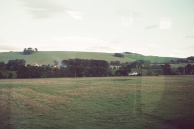 Patchwork green hills and hedgerows from the train — Aberdeen, Scotland (late July - early August 2000)