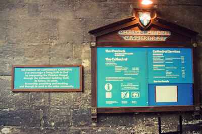 A cathedral notice board mounted on a stone wall — Canterbury, England (mid-August 2000)
