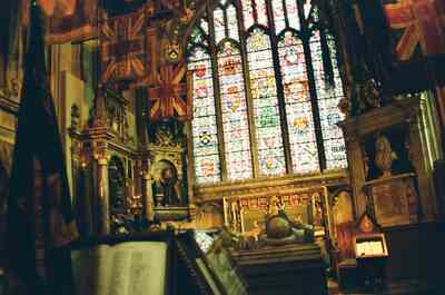 Regimental flags and a stained glass window inside the cathedral — Canterbury, England (mid-August 2000)