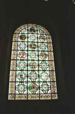 A patterned stained glass window glowing in the dark — Canterbury, England (mid-August 2000)