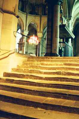 A chandelier glowing among the cathedral's stone columns — Canterbury, England (mid-August 2000)