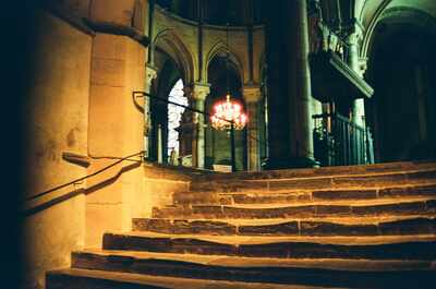 Worn steps to a glowing chandelier — Canterbury
