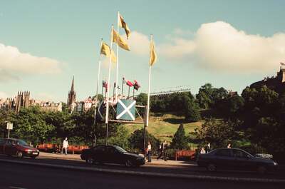 Flagpoles and Edinburgh Castle rising above the gardens — Edinburgh, Scotland (August 2000)