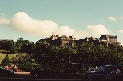Edinburgh Castle on its crag above traffic and trees — Edinburgh, Scotland (August 2000)