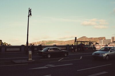 A street and lamppost with Arthur's Seat beyond — Edinburgh, Scotland (August 2000)