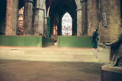 A visitor gazing up at St Giles' Cathedral stained-glass window — Edinburgh, Scotland (August 2000)