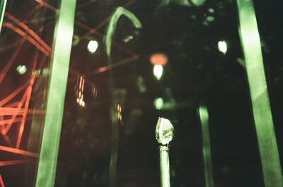 An illuminated gem on a column in the jewels display — London, England (August 2000)