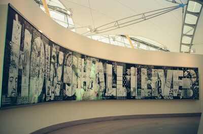 A long curved 'Self portrait' photo-collage mural — London, England (August 2000)