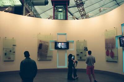 Visitors in the circular Faith zone with a glass lift — London, England (August 2000)