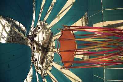 An orange canopy hanging beneath the blue tent roof — London, England (August 2000)