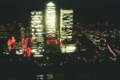 Canary Wharf towers lit up at night — London, England (August 2000)