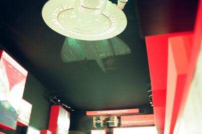 A starship model suspended in a darkened transport exhibit — London, England (August 2000)