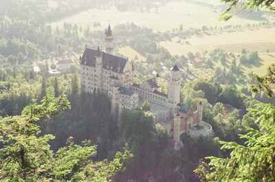 Neuschwanstein Castle viewed from a wooded hilltop — Fussen, Germany (19-21 June 2000)