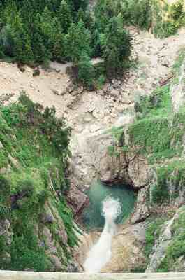 A waterfall plunging into a turquoise gorge pool — Fussen, Germany (19-21 June 2000)