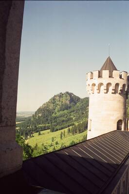 A turret of Neuschwanstein Castle above the valley — Salzburg, Austria (19-21 June 2000)