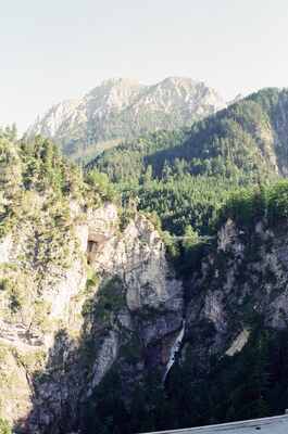 A pine-clad cliff face on a rugged mountainside — Fussen, Germany (19-21 June 2000)