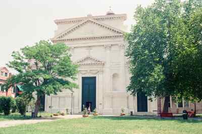 A classical white church facade across a grassy campo — Venice, Italy (7-10 June 2000)