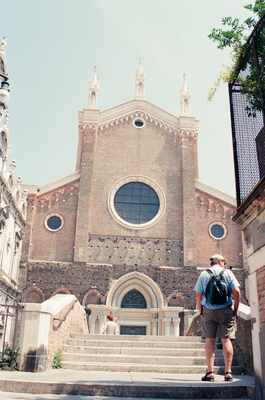 Travellers resting before the Frari basilica facade — Venice, Italy (7-10 June 2000)