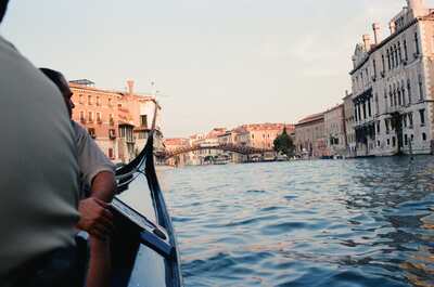 Gondolier rowing toward the Accademia bridge at sunset — Venice, Italy (7-10 June 2000)