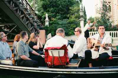 A guitarist serenading passengers during a gondola ride — Venice, Italy (7-10 June 2000)