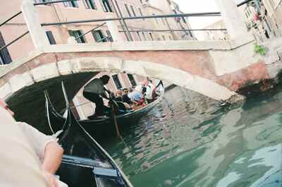 A gondola passing under an arched canal bridge — Venice, Italy (7-10 June 2000)