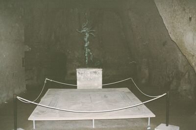 A roped-off statue in a dim excavated interior — Pompeii, Italy (4-6 June 2000)
