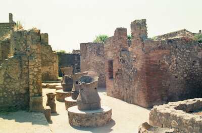 Stone grain mills among the ruined walls of Pompeii — Herculaneum, Italy (4-6 June 2000)