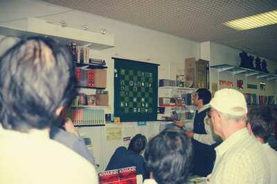 A man giving a chess simul at the Chess and Bridge shop — London, England (August 2000)