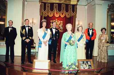 Waxwork royals in formal dress before a throne — London, England (20-25 July 2000)