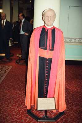 A waxwork cardinal in pink and black robes — London, England (20-25 July 2000)