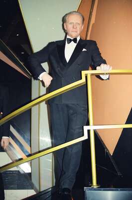 A waxwork of a man in a tuxedo on a mirrored stair — London, England (20-25 July 2000)