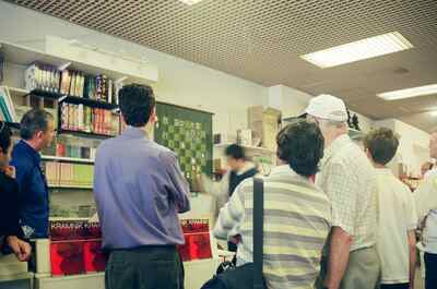 Visitors browsing chess books in a busy shop — London, England (13-20 July 2000)