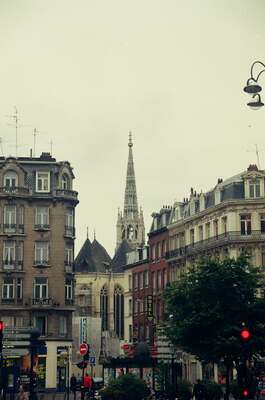 A Gothic church spire rising above ornate buildings — Nice, France (13-20 July 2000)
