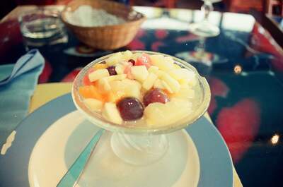 A glass dish of mixed fruit salad on a cafe table — Nice, France (13-20 July 2000)