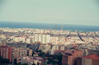 Hazy view over rooftops to the sea from Park Guell — Barcelona, Spain (13-20 July 2000)