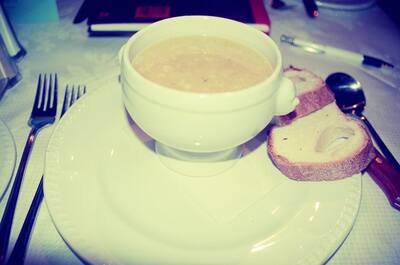A bowl of cream soup with bread on a set restaurant table — Glasgow, Scotland (late July 2000)