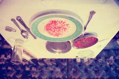 A curry with pink-tinted rice on a restaurant table — Glasgow, Scotland (late July 2000)