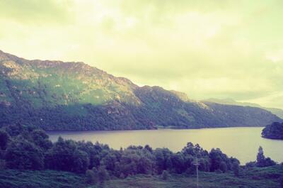 Forested hillsides flanking a calm Highland loch — Oban, Scotland (late July 2000)