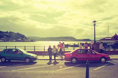 Parked cars and strollers along the Oban waterfront — Oban, Scotland (late July 2000)