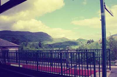 A Highland railway platform with hills beyond — Scottish Highlands, Scotland (late July 2000)